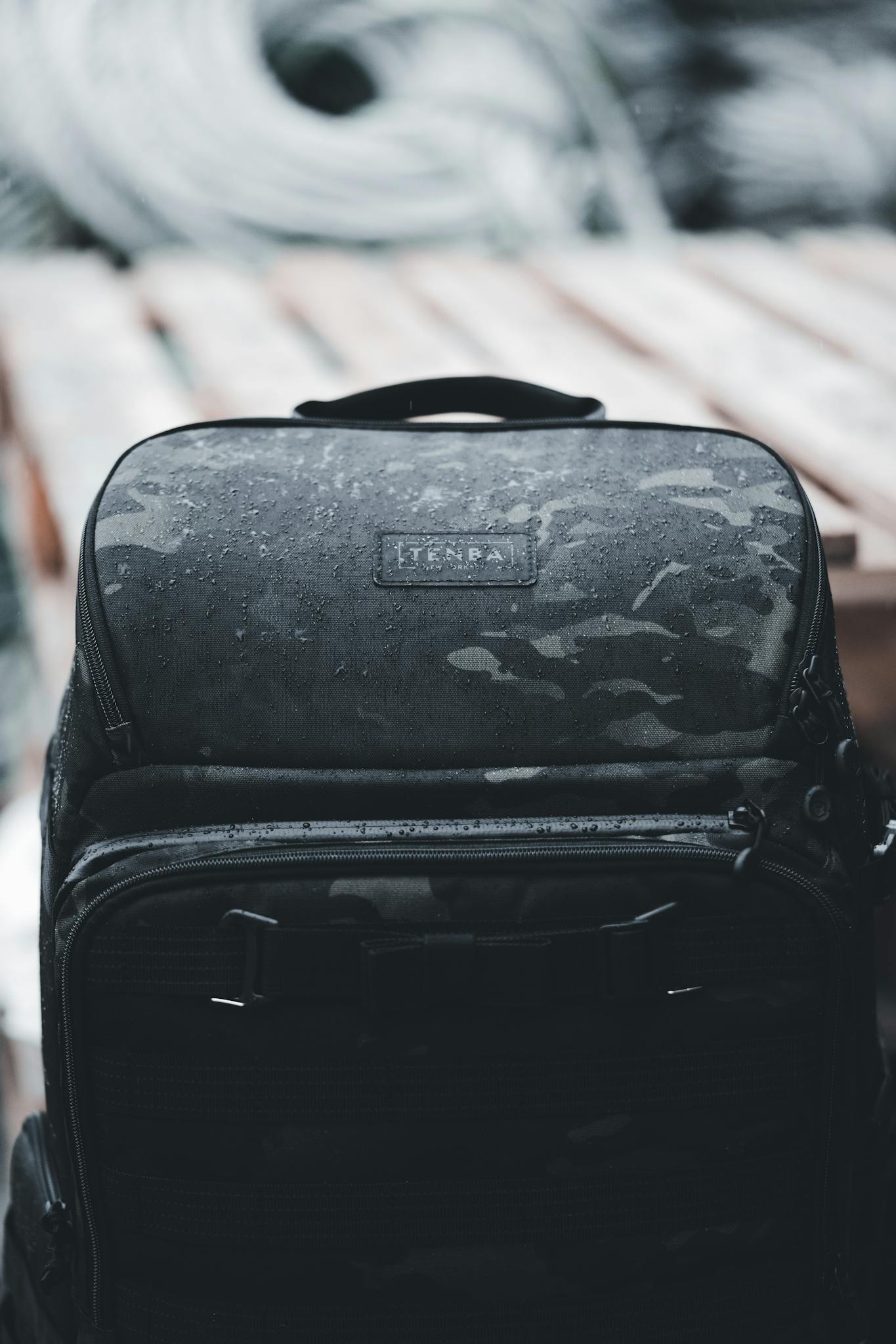A rugged waterproof backpack with camo pattern, ideal for outdoor adventures in wet conditions.